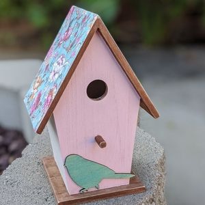 Birdhouse with colorful floral decoupage roof